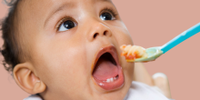 Baby being spoon-fed Live Indianly clean Indian baby food